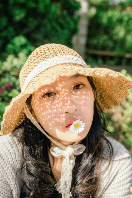 a person wearing a straw hat and a flower