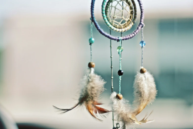 there are beads on the wind chime with feathers