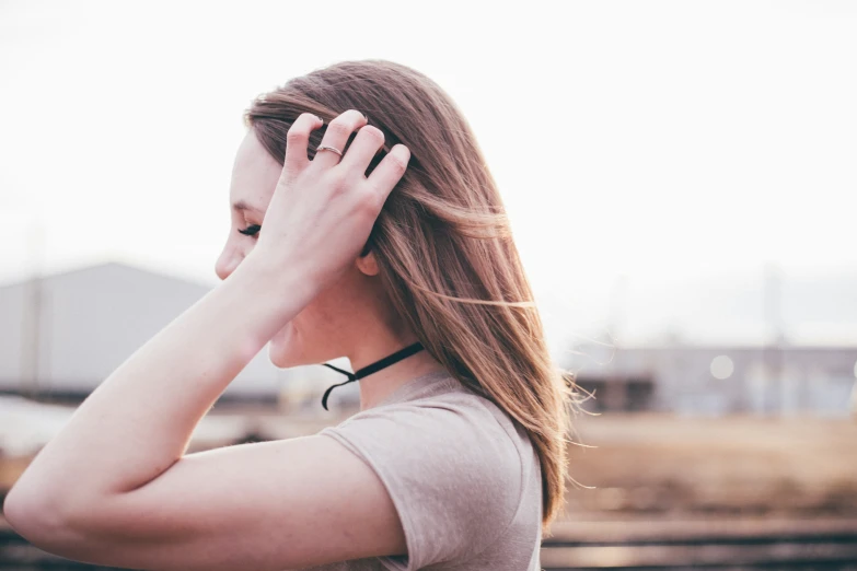 a woman with long hair holds her hands to the side