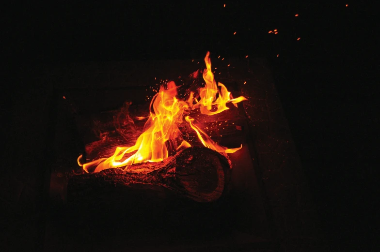 fire blazing at night, burning in a square container