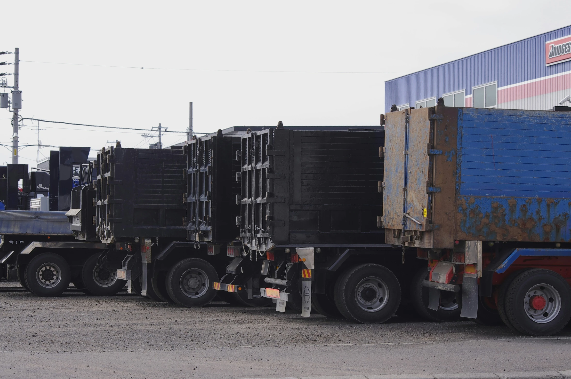 semi trucks parked next to each other at a parking lot