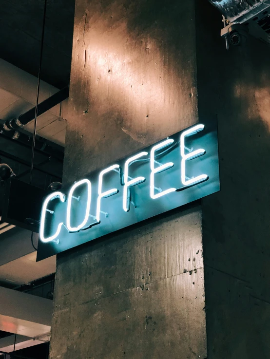 illuminated coffee sign on the side of a building
