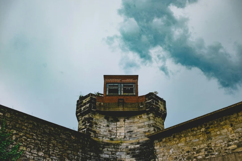 looking up at an old tower and sky