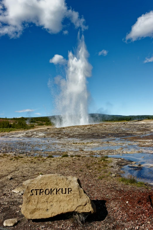 a large rock with water coming from it