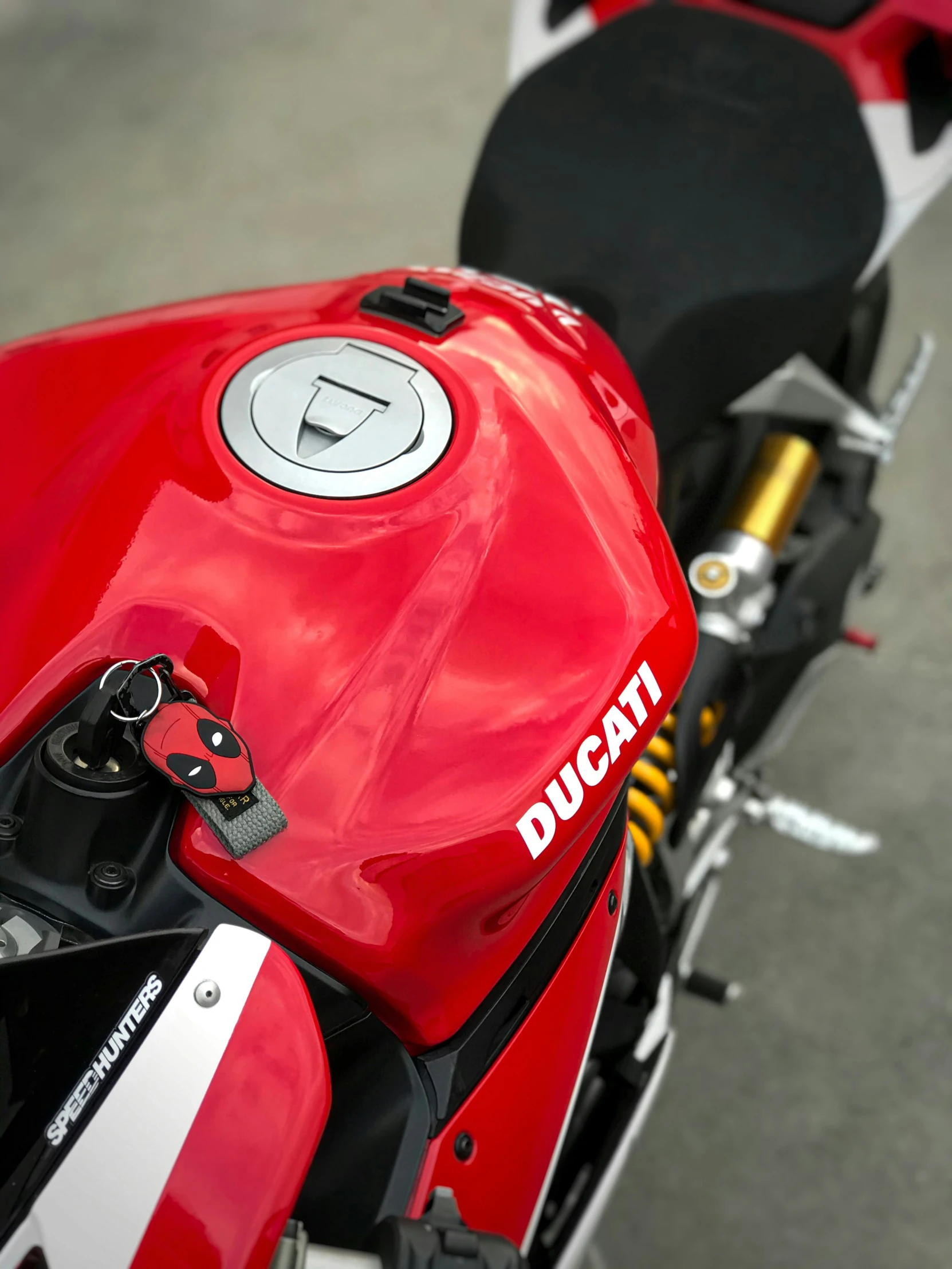 a red motorcycle is parked near the pavement