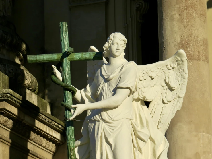 a statue that has been put up next to a cross