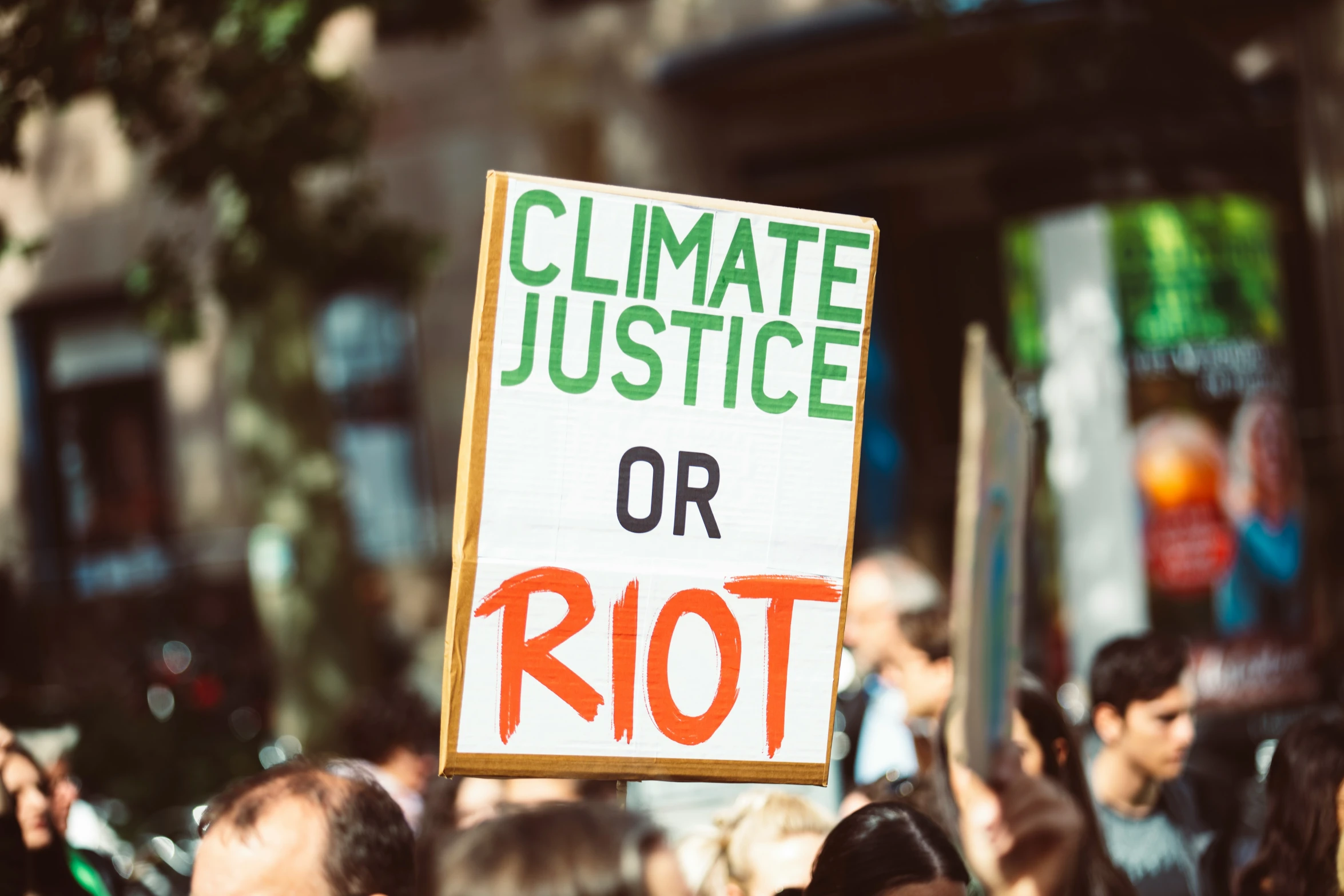 protestors holding signs while outside during the day