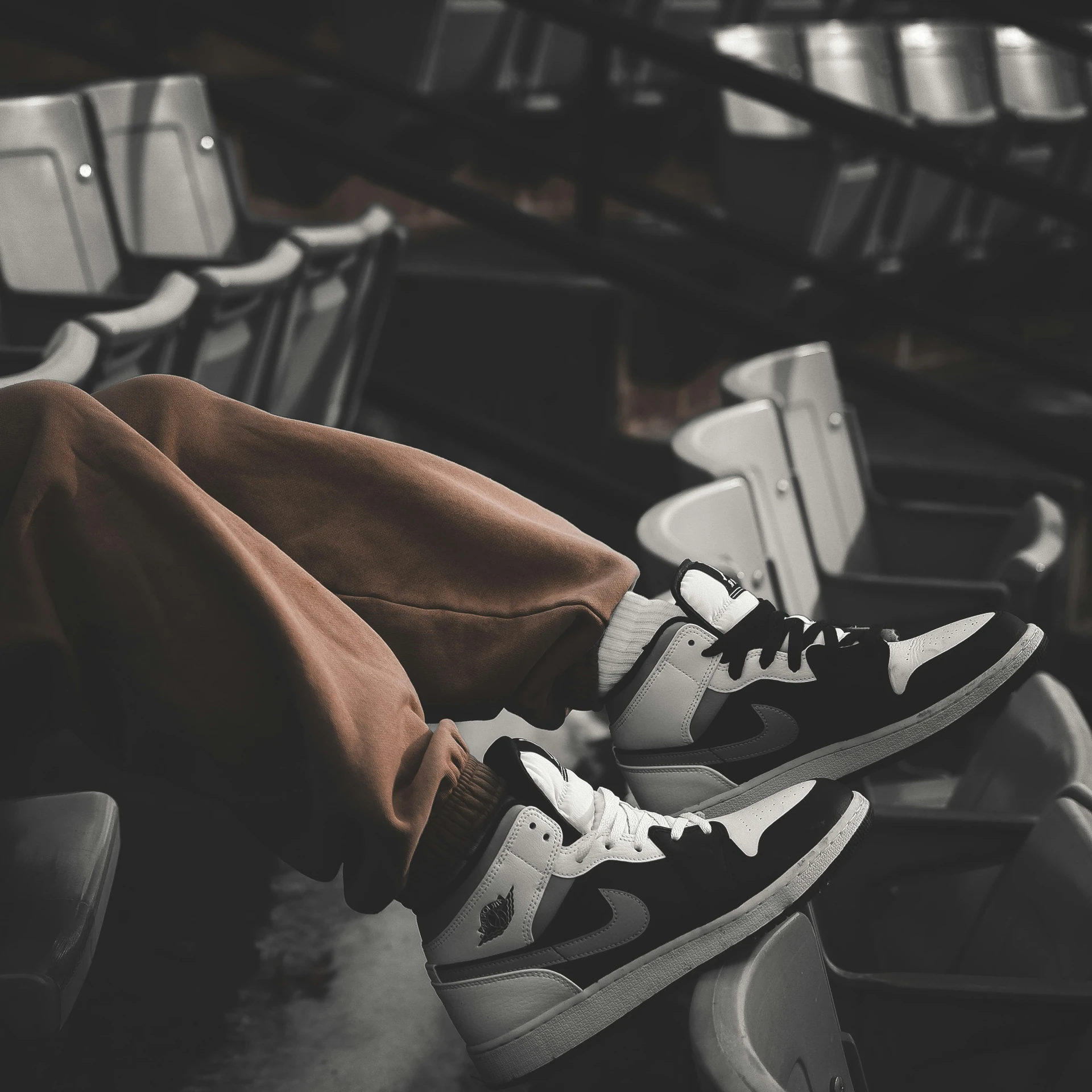 a person standing in the middle of a bench wearing sneakers