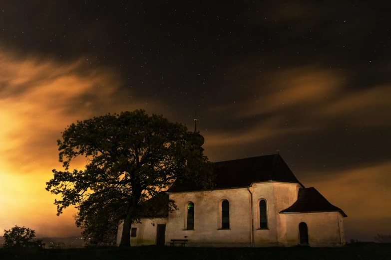 a church lit by the lights of other buildings