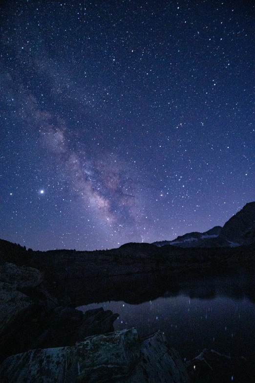 some mountains lights and stars at night