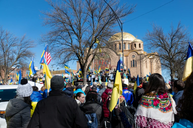 people with flags marching through the streets