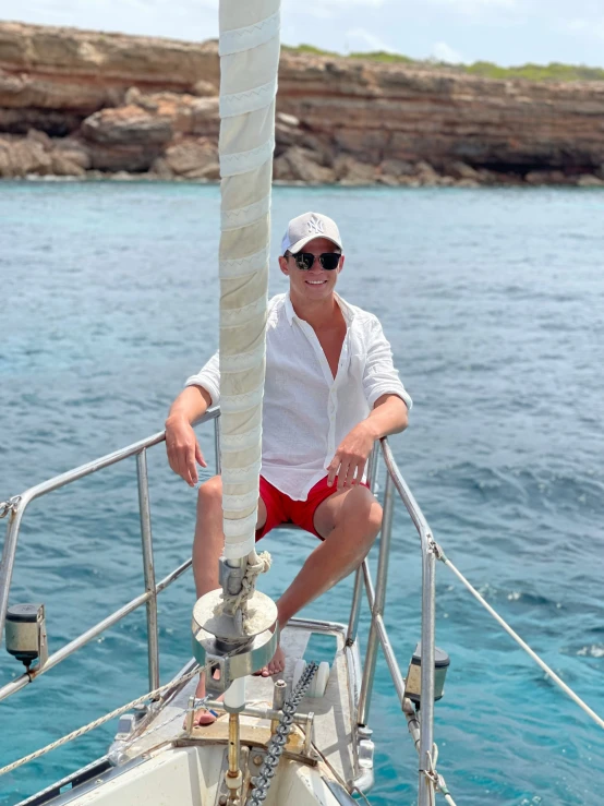 man wearing sun glasses on sailboat in open water