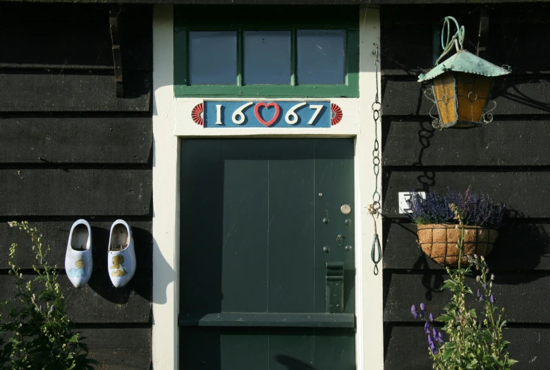 three flowerpots are hanging next to a door on a black wall