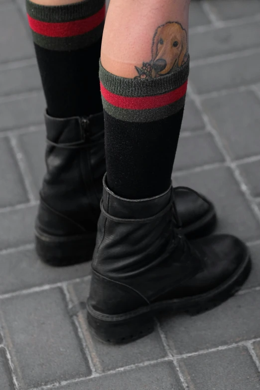 a close up of a person wearing black boots