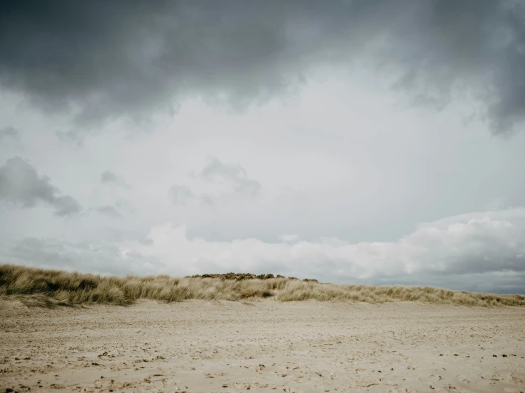 man and woman in the desert under an overcast sky