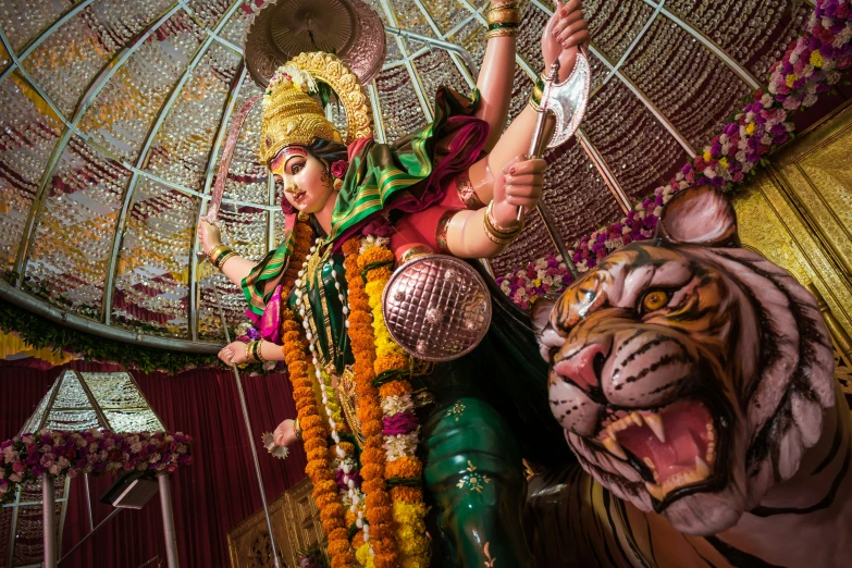 an elaborately decorated woman and tiger statue in a fancy area