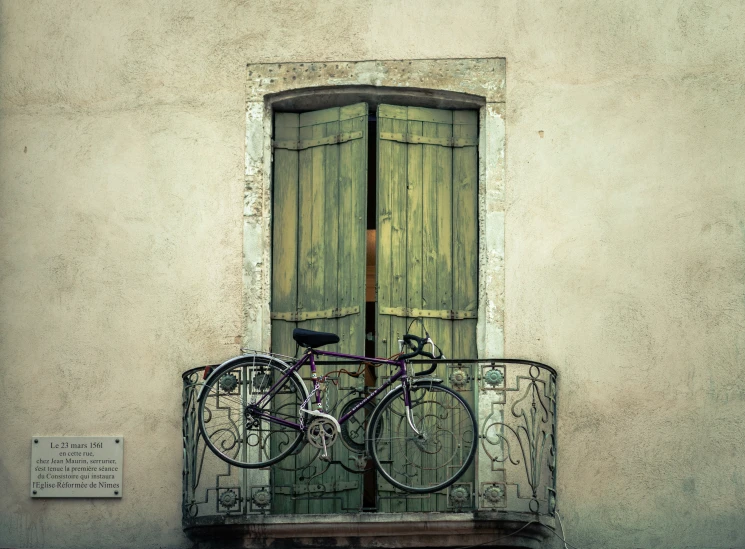 a bike is parked up outside of an old house