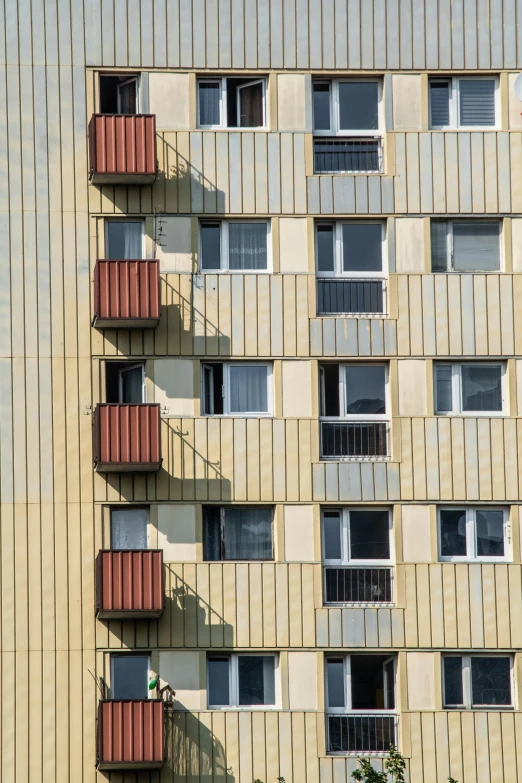 a tall building has several balconies in the window