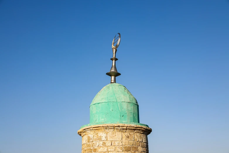 a building with a tall tower and a light pole near it