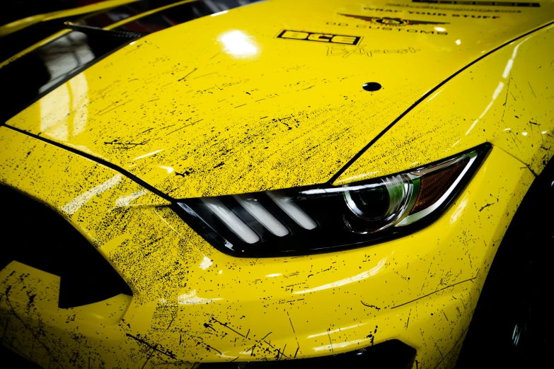 a yellow mustang car is pictured with very little shading