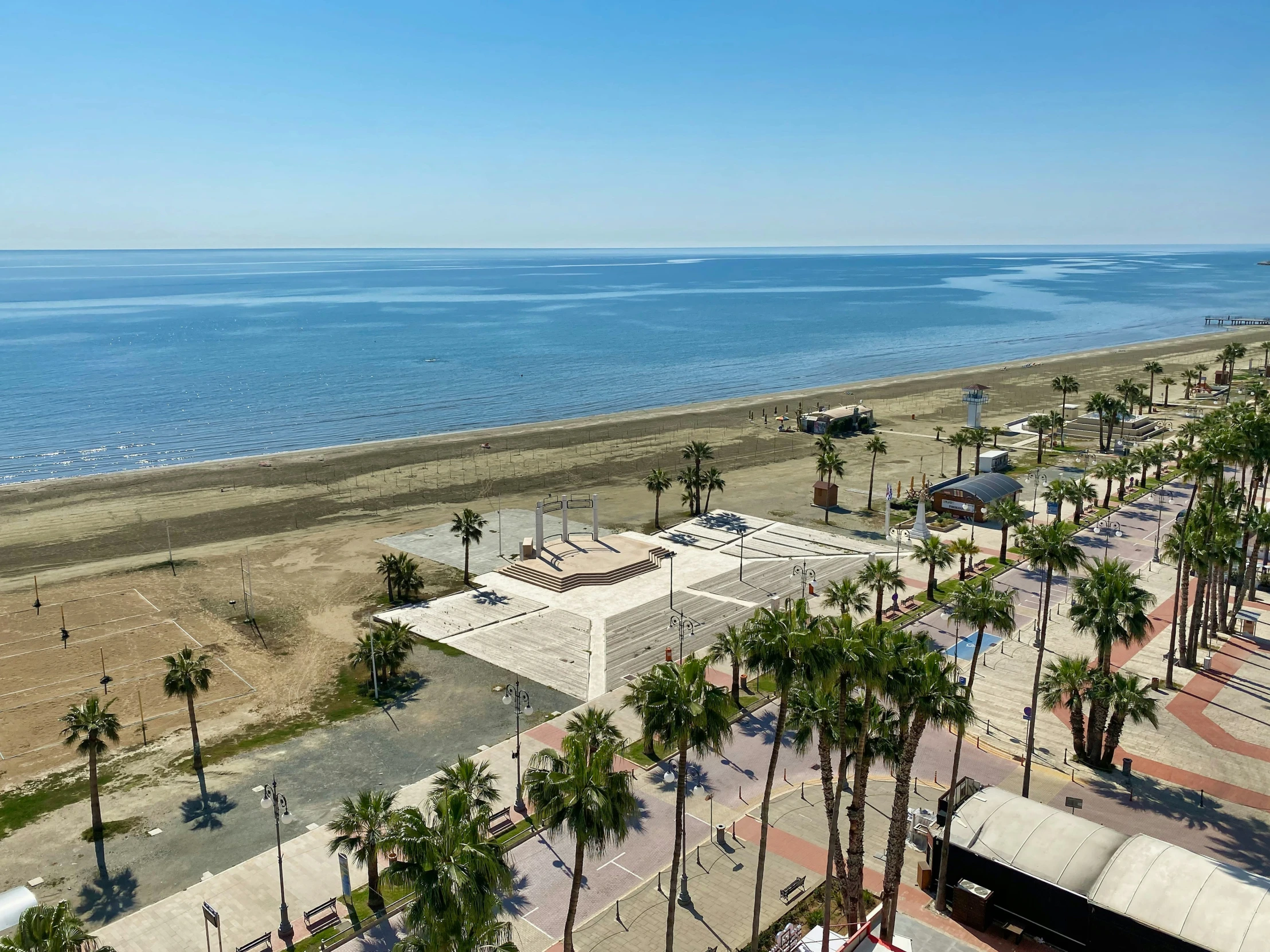 a view of the beach and boardwalks near an ocean