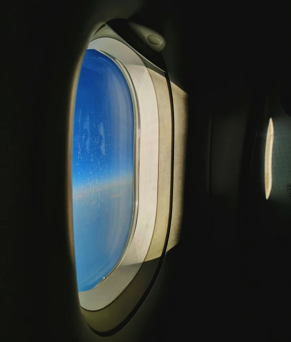 an airplane's window at night as seen from inside the airplane