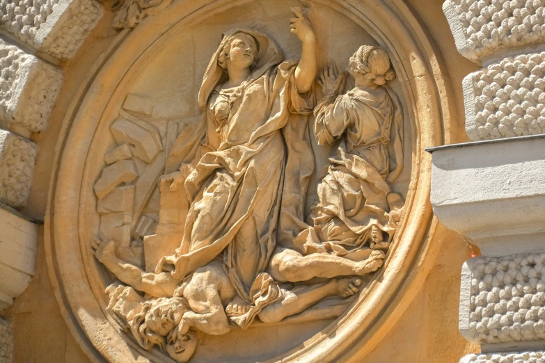 stone relief of a lady on a wall