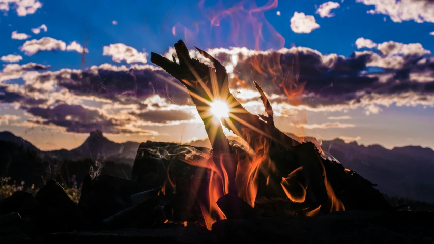 the sun shining brightly through a group of rocks