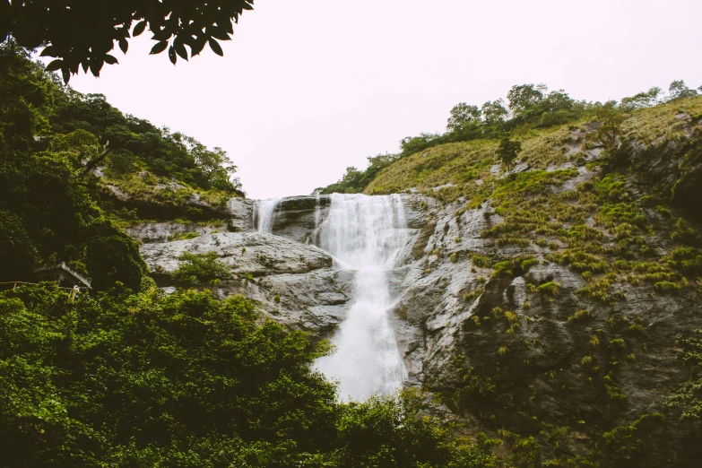 a waterfall pouring out of a narrow river