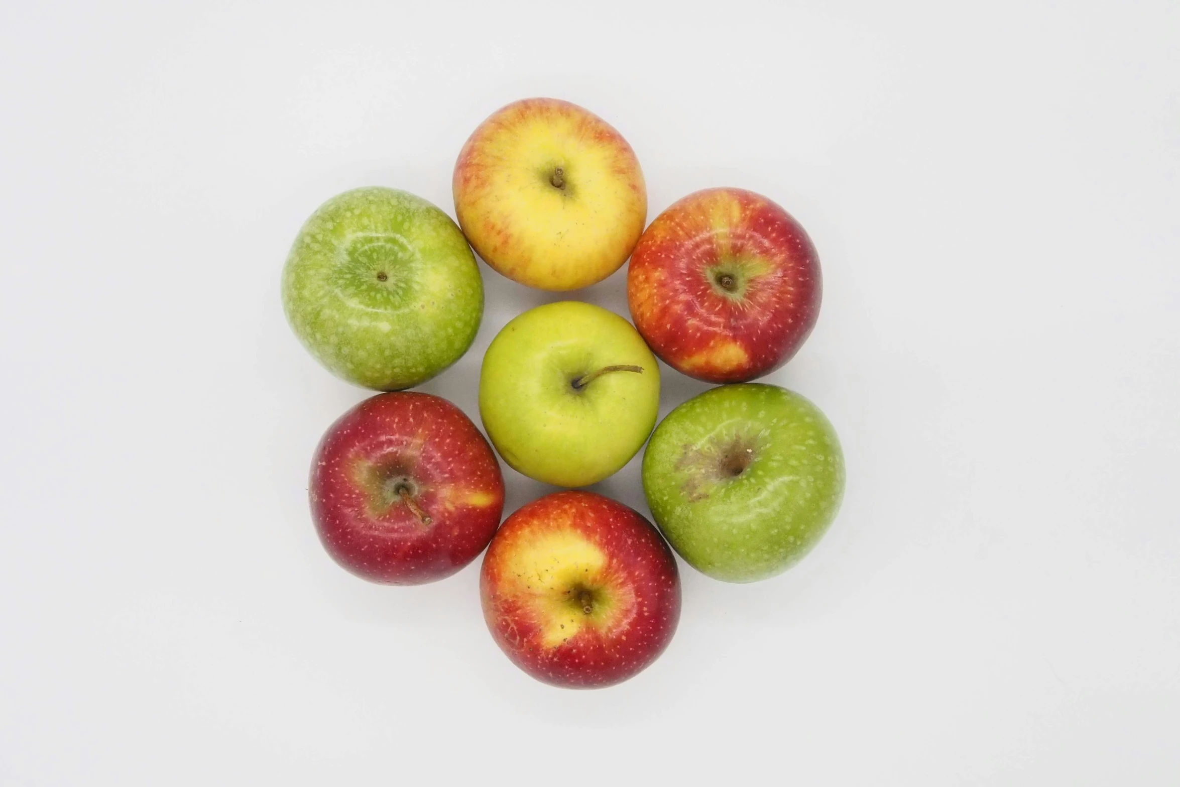 seven apples arranged together in a triangle