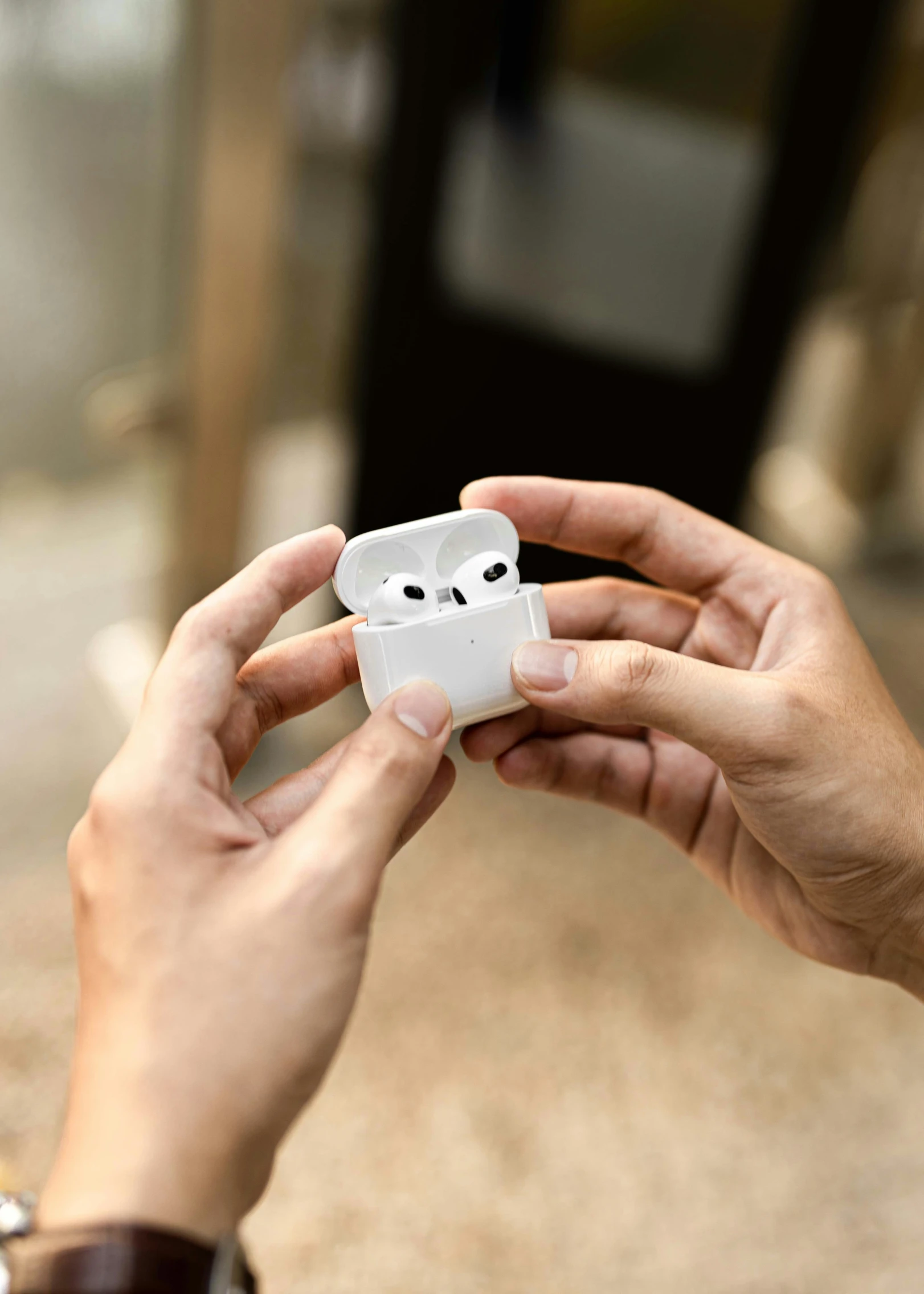 a woman holding an apple airpods case with two faces