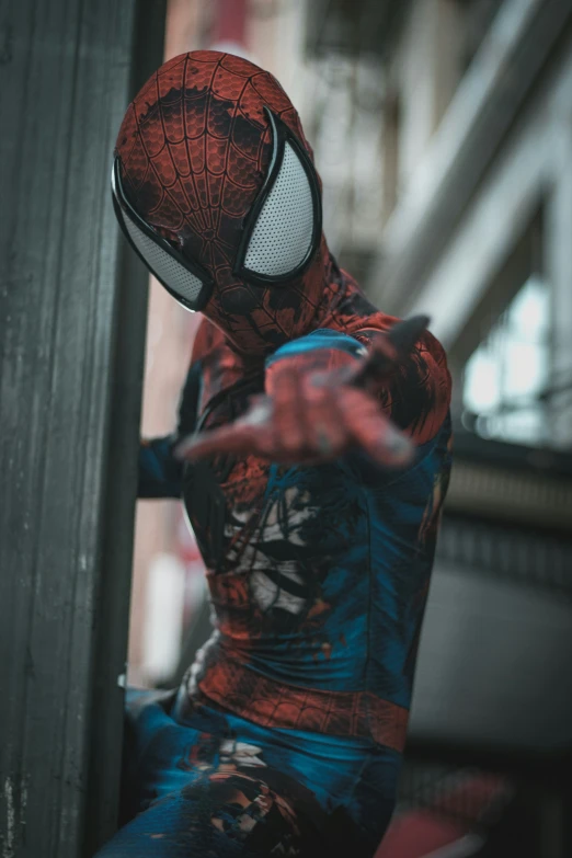 a person wearing a spider man suit posing for a po