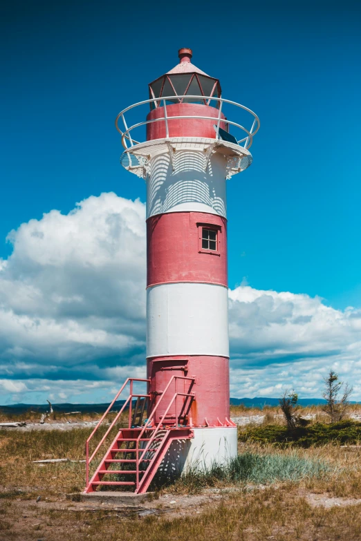 there is a red and white lighthouse with a red stairs