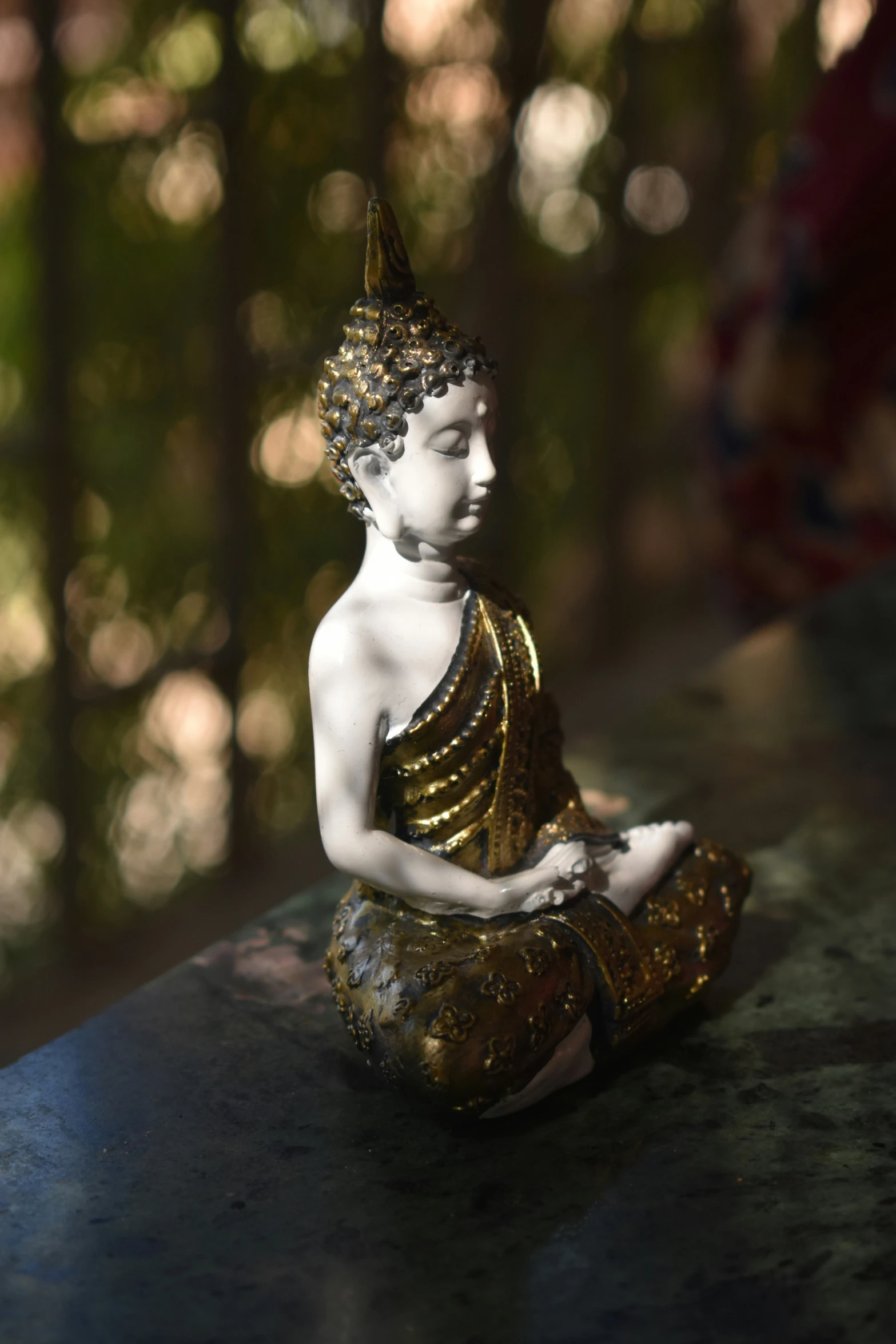 a small buddha statue sits atop a counter