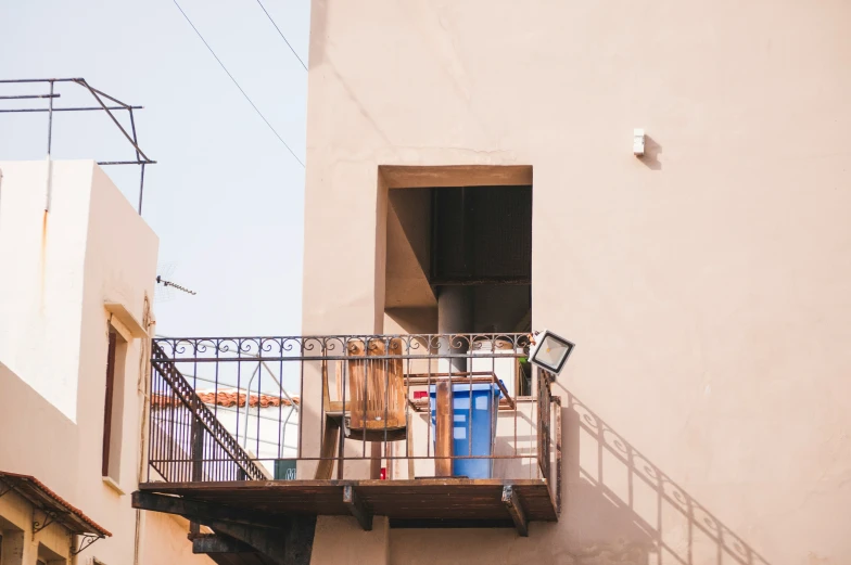 a balcony with furniture and stairs going up and down it