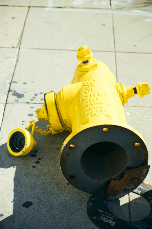a yellow fire hydrant laying on top of the ground
