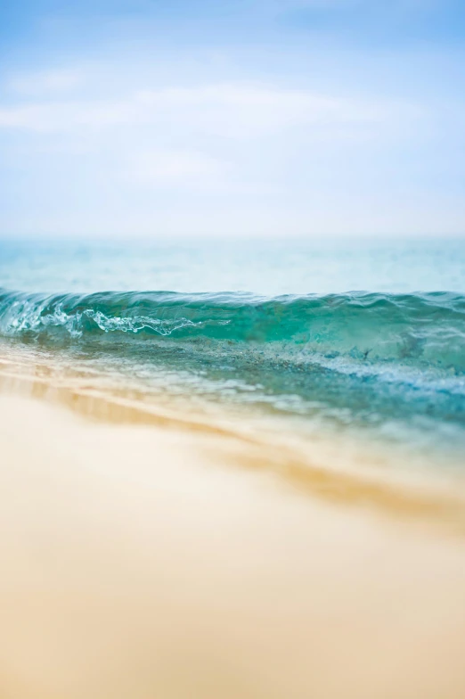 a beach with the ocean water and sand