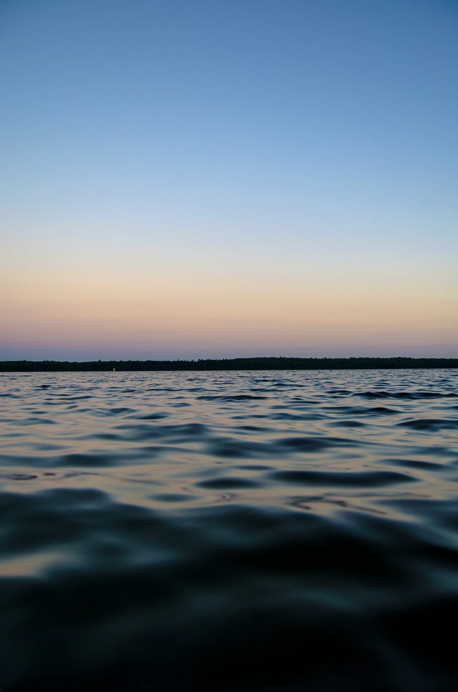 water and sky at dusk as seen from a boat