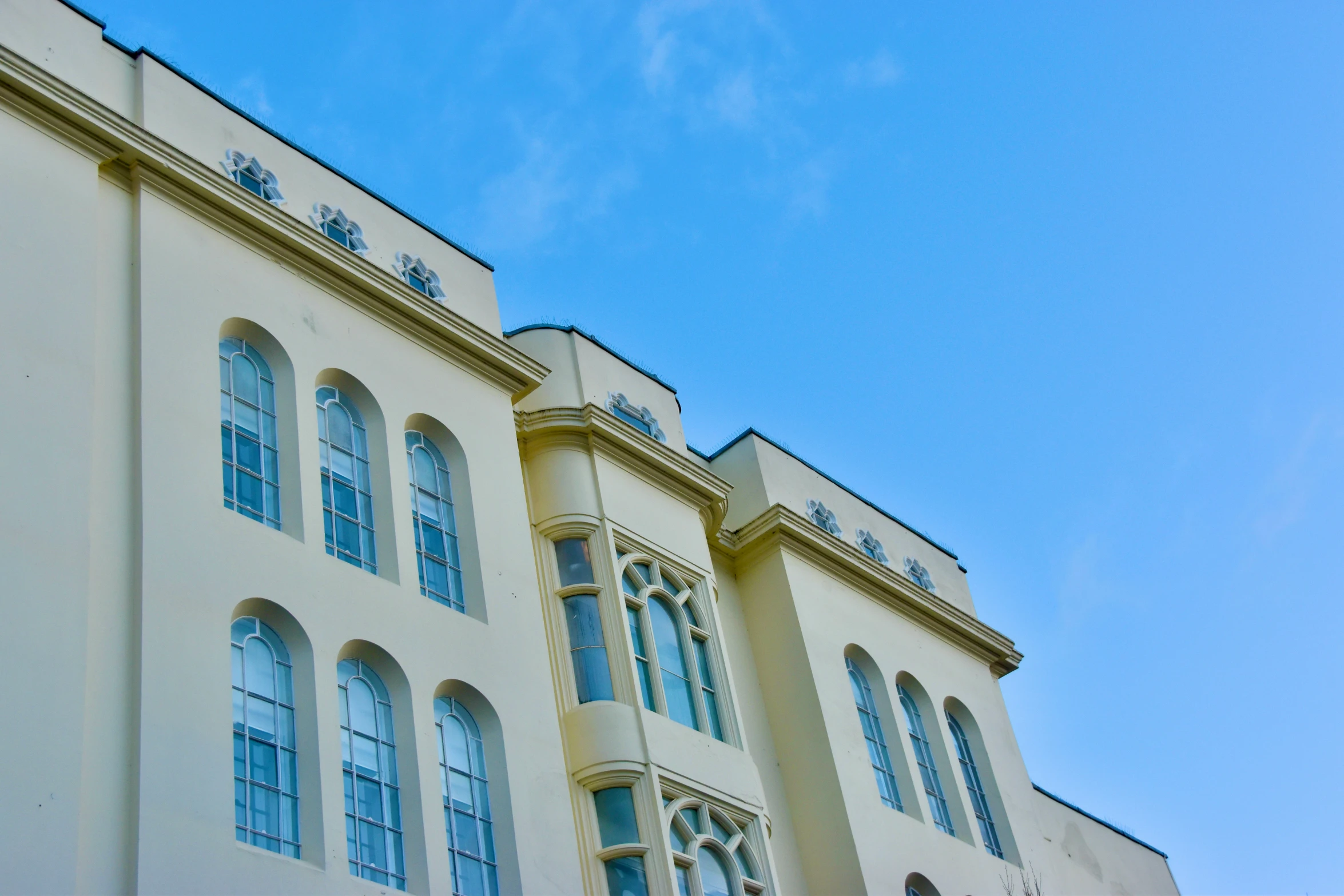 two buildings with blue sky behind them are seen