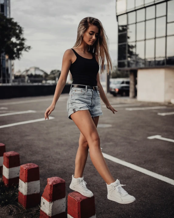 a woman posing in an empty parking lot