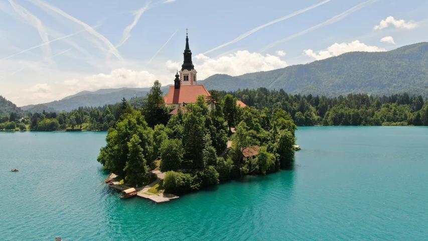 a small island is surrounded by blue water