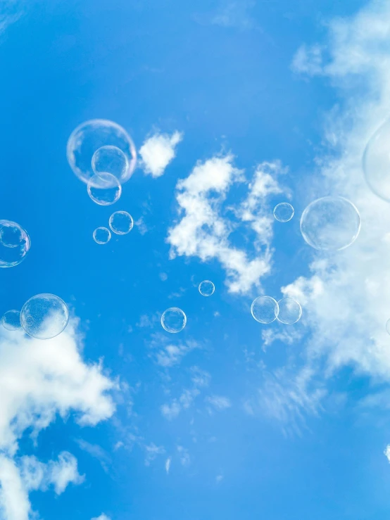 soap bubbles floating on a cloudy blue sky