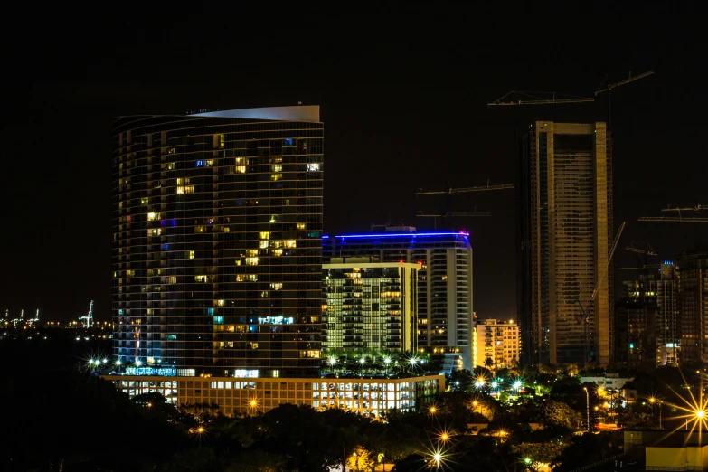 night time view of the city skyline with buildings