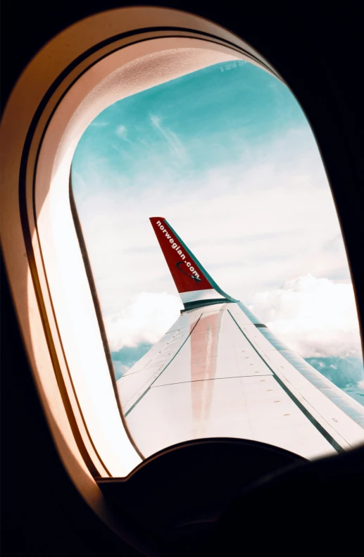 airplane wing from the window as it flies through the sky