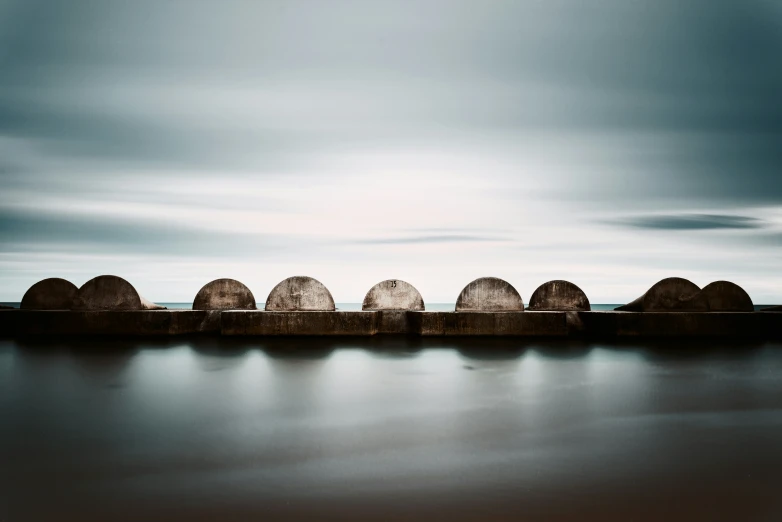 a set of round structures that have been placed at the edge of a body of water