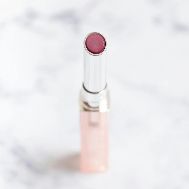 a lipstick tube sitting on top of a marble counter