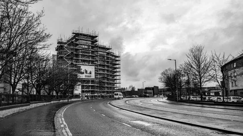 building being constructed with scaffolding in black and white