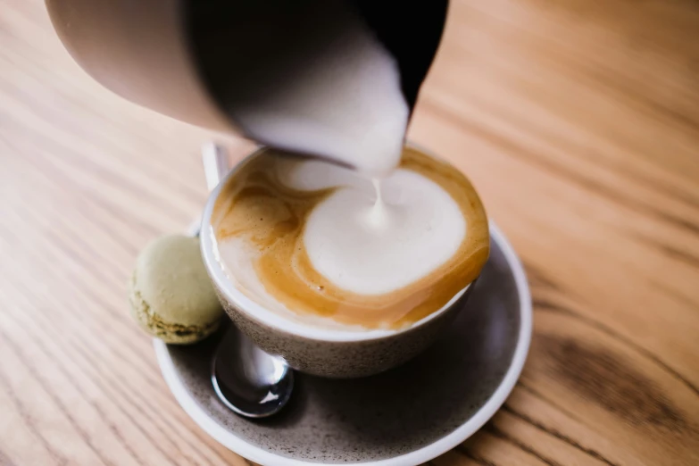 some ice cream being poured into a mug