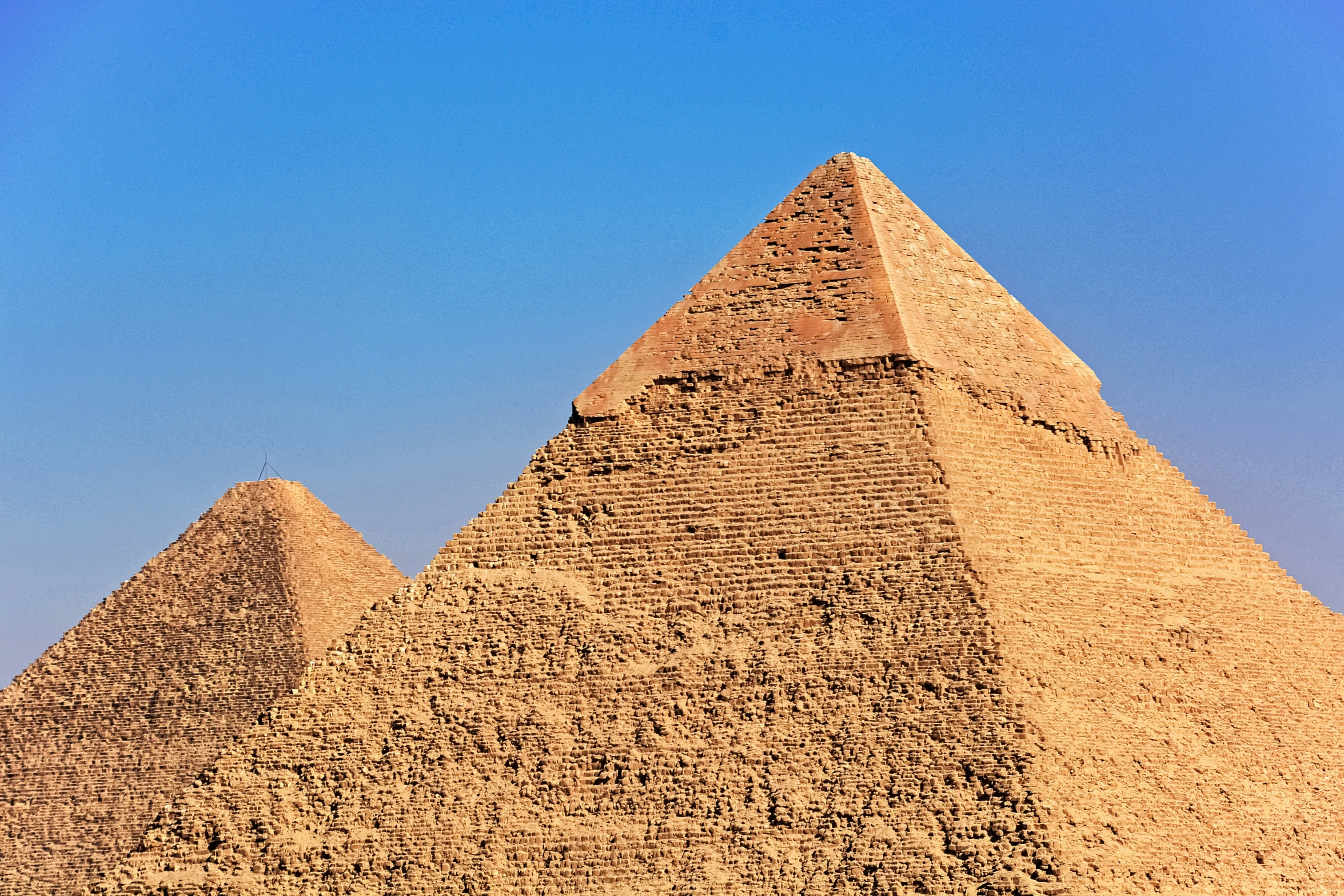 three pyramids are shown in the desert