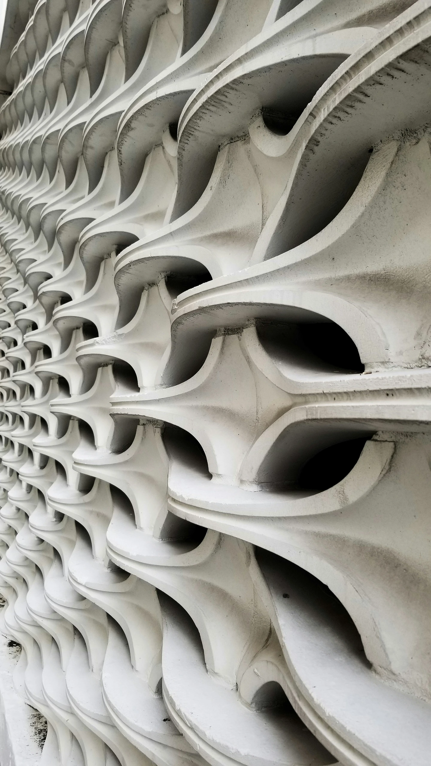 an intricately designed wall of white cement